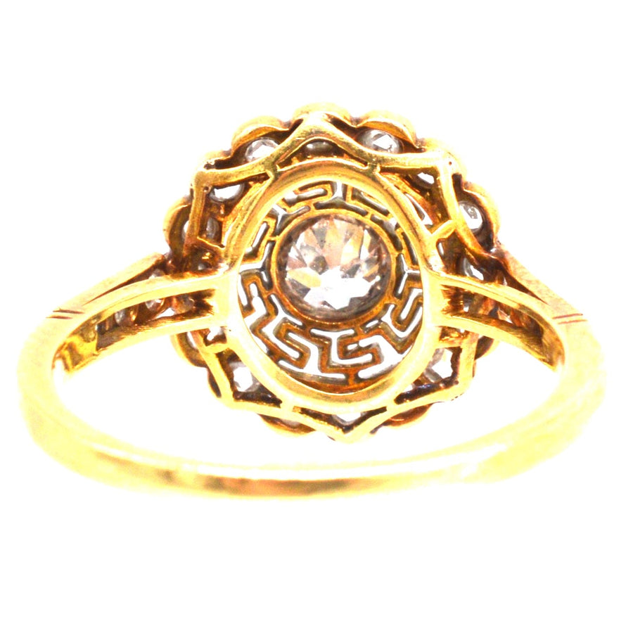 Art Deco 18ct gold and platinum ring featuring a diamond and Greek key design, showcasing vintage elegance.