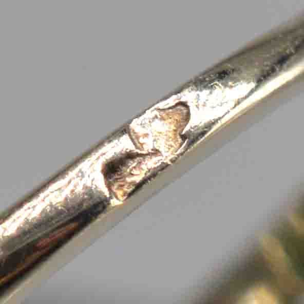 Close-up view of the hallmark and detail on the band of a vintage ring.
