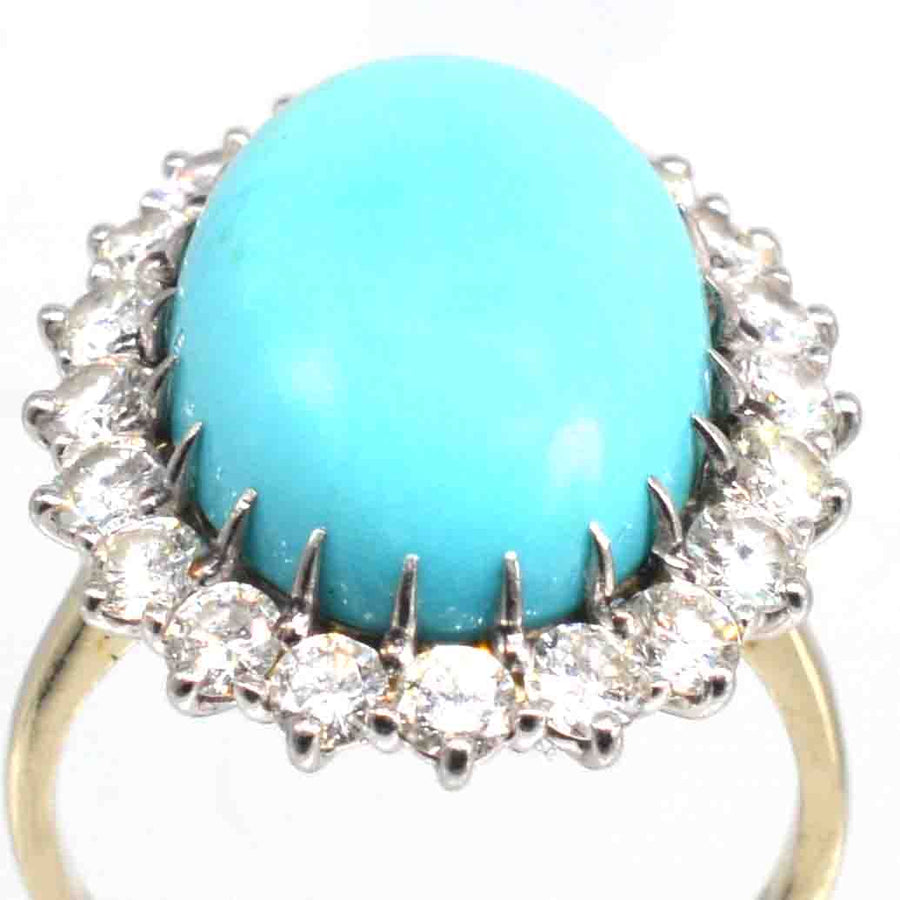 French vintage turquoise and diamond cluster cocktail ring showcasing an oval turquoise stone surrounded by sparkling diamonds.