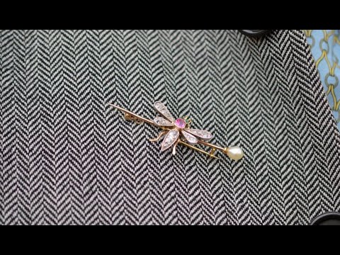 Edwardian platinum and gold bug brooch with pink sapphire, emerald eyes, diamond wings, and natural pearl.
